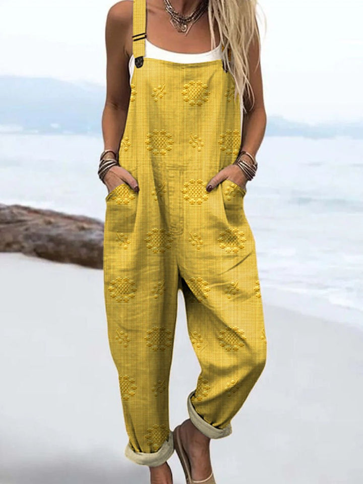 Dame jumpsuit med justerbare stropper og flydende vidde ben. Ultimativ komfort og stil.