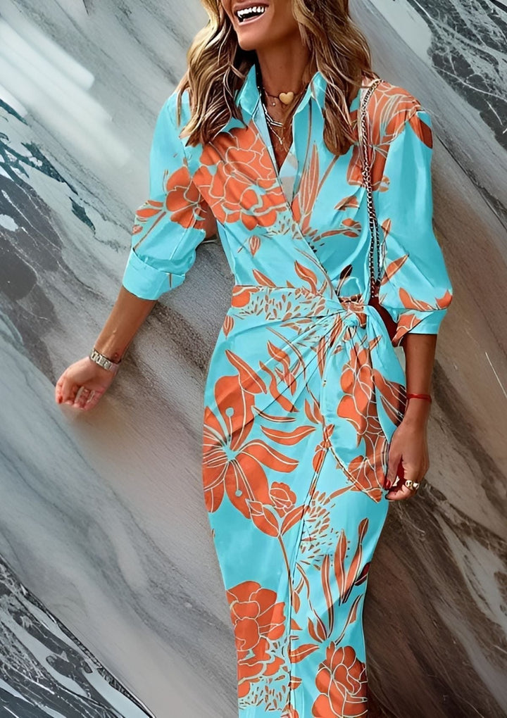 Marineblå/turkis omslagskjole med stilfuldt mønster. Amalia kjolen er en komfortabel og elegant sommer-festkjole.