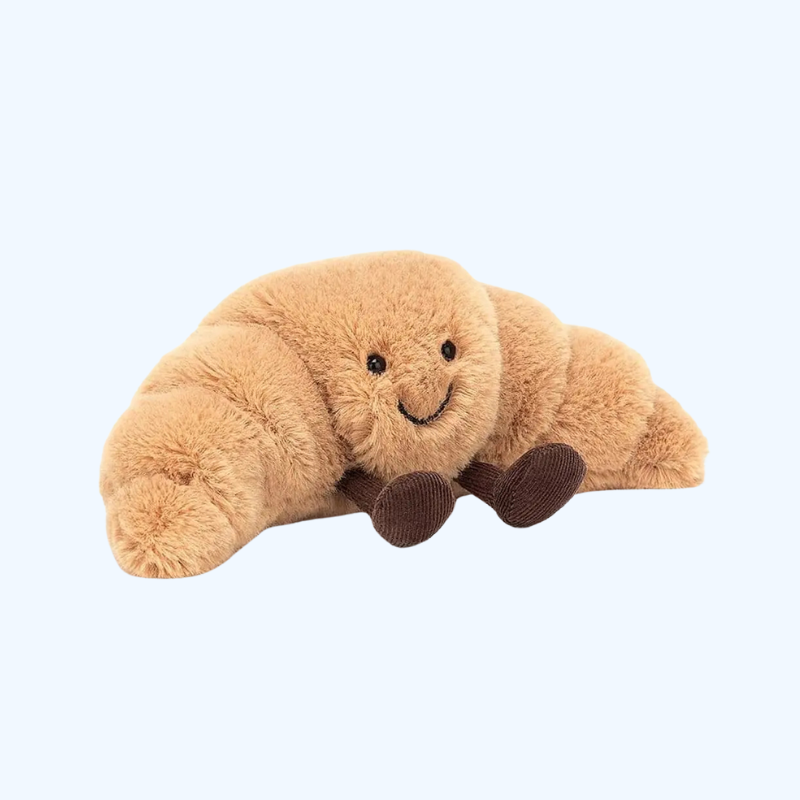 Croissant plysdyr, en blød krammebamse der spreder hygge og smil i hjemmet.