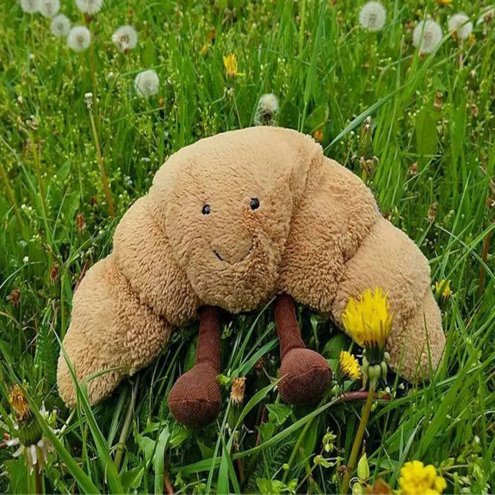 Hyggelig croissant krammebamse, et charmerende og blødt plysdyr til legetid.