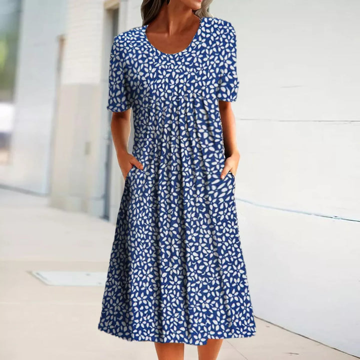 "Blomstret sommer midi kjole, let stof, afslappet pasform, lommer, feminint design, perfekt til varme dage"