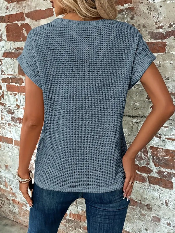 Detaljebillede af en dames T-shirts snoet hals; viser den unikke rundhals.