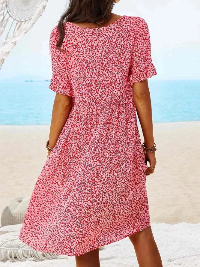 Afslappet sommerkjole med blomsterprint, A-silhuet og flutterærmer. Perfekt som strandkjole eller feriekjole.