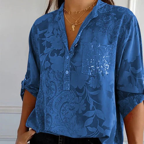 Elegant langærmet damebluse med blomsterprint og V-hals, perfekt til et feminint look.