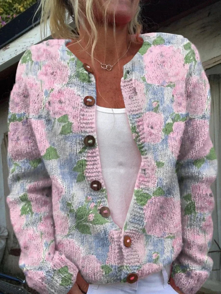 "Elegant blomstrede strikjakke til damer, front view, med farverige blomstermønstre, ideel til både arbejds- og fritidsbrug."