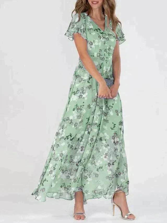 "Elegant blomstret maxi kjole med V-hals og flydende silhuet, ideel til kvinder, der søger et moderne og feminint look."