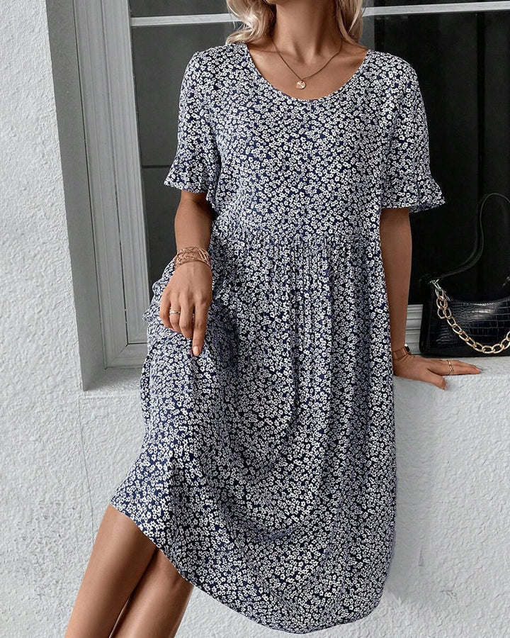 Elegant forårs- og sommerkjole: Blomstret midikjole til kvinder med feminint snit.