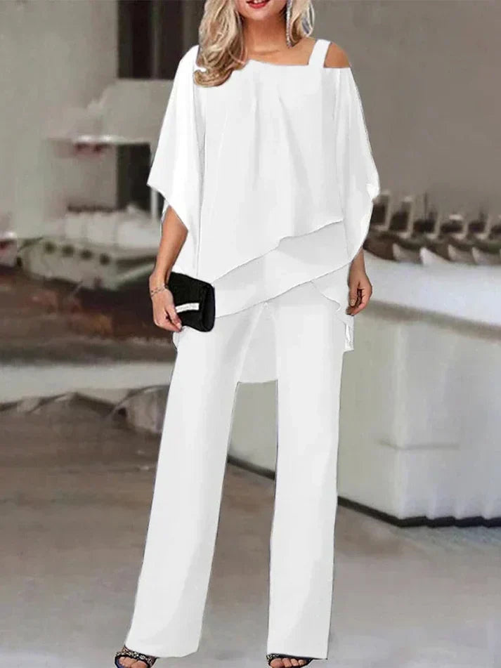 "Elegant dame buksedragt med asymmetrisk design, off-shoulder og brede bukseben, perfekt til festlige lejligheder."