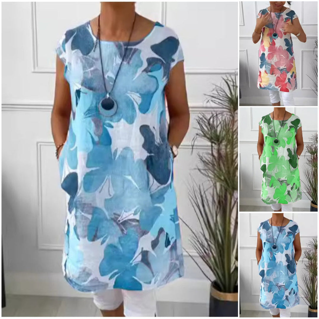 Elegant dame skjortekjole med farverigt sommerfugleprint. Knælang og løs pasform, perfekt til hverdag.