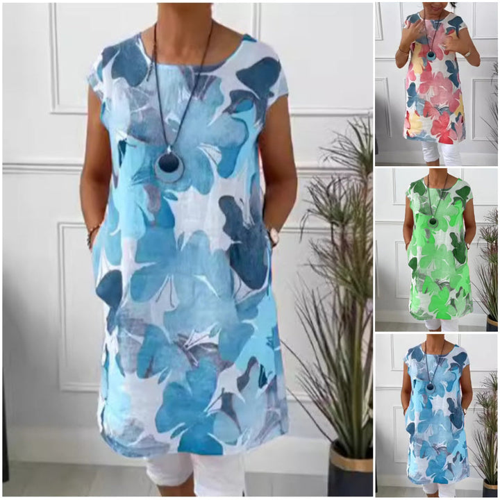 Elegant dame skjortekjole med farverigt sommerfugleprint. Knælang og løs pasform, perfekt til hverdag.