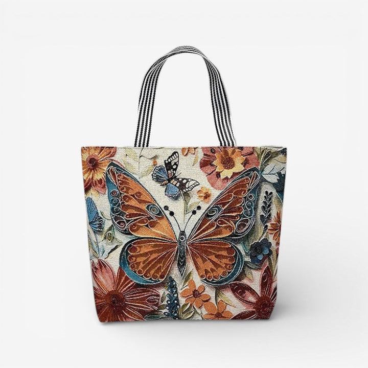 Kvinde bærer en praktisk dame tote taske med broderi. Elegant design, rummelig og ideel til hverdagsbrug.