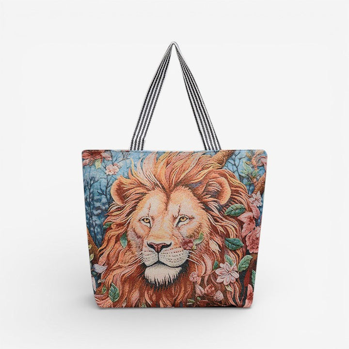 Stilren dame tote taske med broderi, set fra siden, viser dens elegante form og solide stropper.