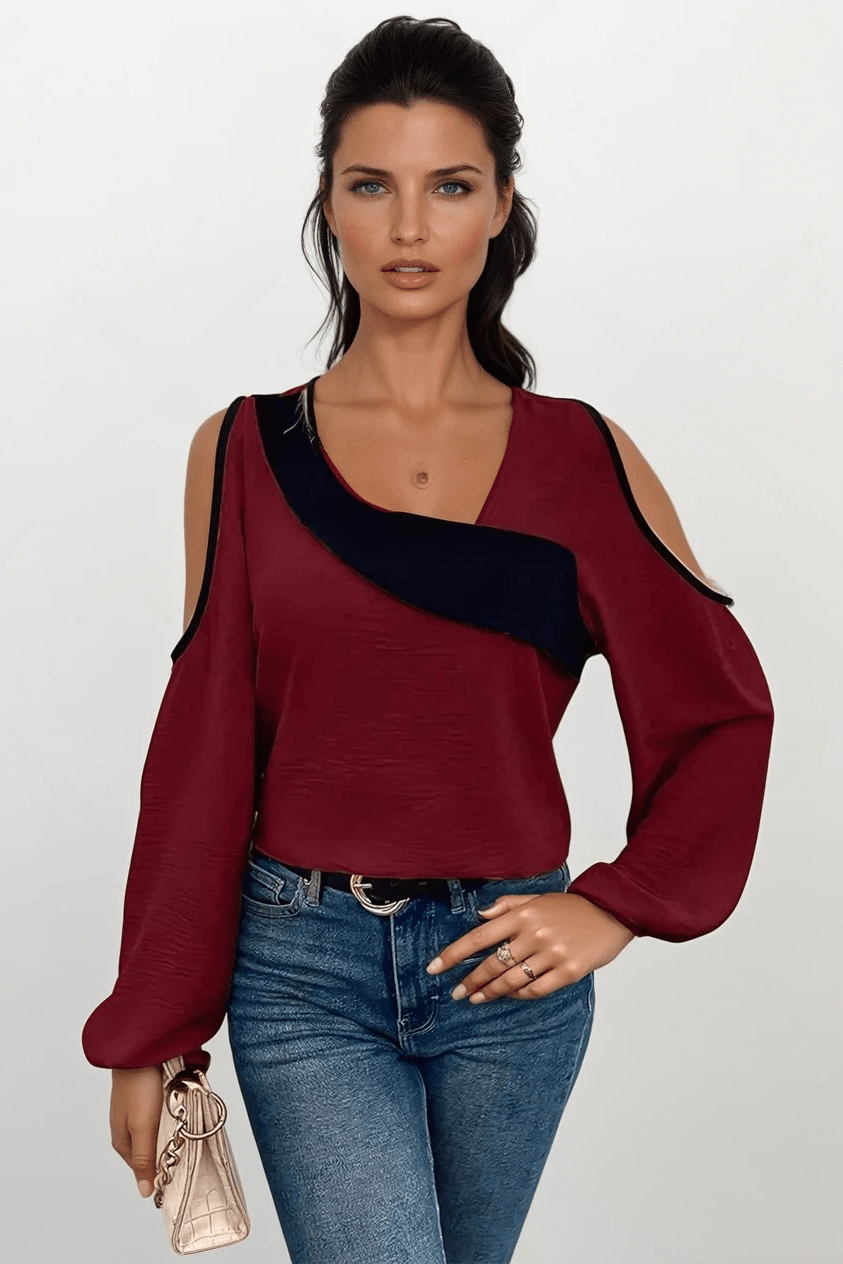 Elegant damebluse med asymmetrisk snit og åbne skuldre. Moderne og feminin stil til hverdag og aften.