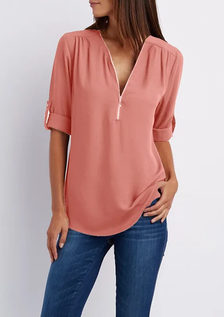 "Elegant damebluse med lynlås og blødt materiale, fås i flere farver. Perfekt til både hverdags- og festbrug."