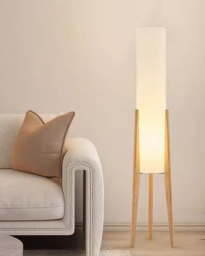 "Elegant gulvlampe i valnød med nordisk retrodesign, solid træbase og blød stofskærm, skaber hyggelig belysning."