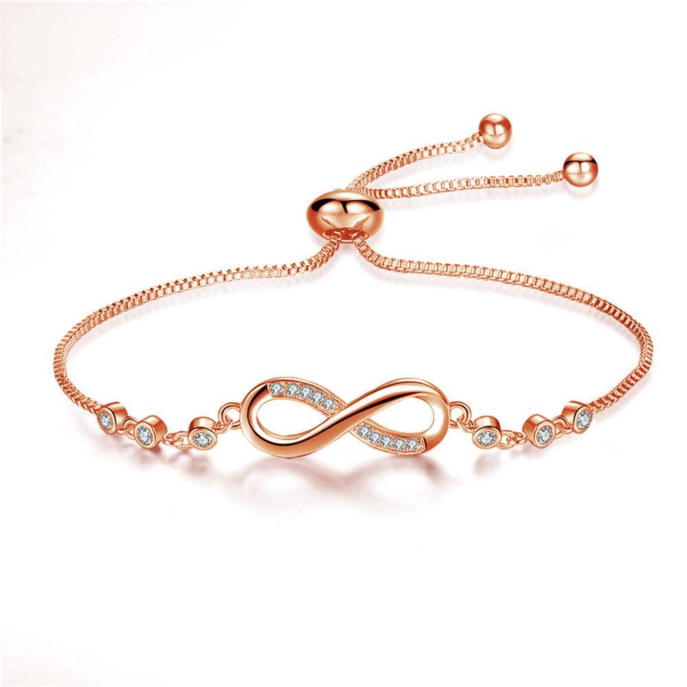 Stilrent guld damearmbånd med justerbart infinity symbol. Et alsidigt kvindesmykke der passer til alt.