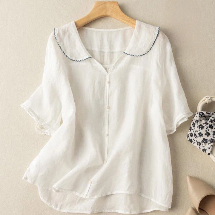 Tidløs elegant kvindebluse med vintage præg. En komfortabel, langærmet stil, perfekt til enhver lejlighed.