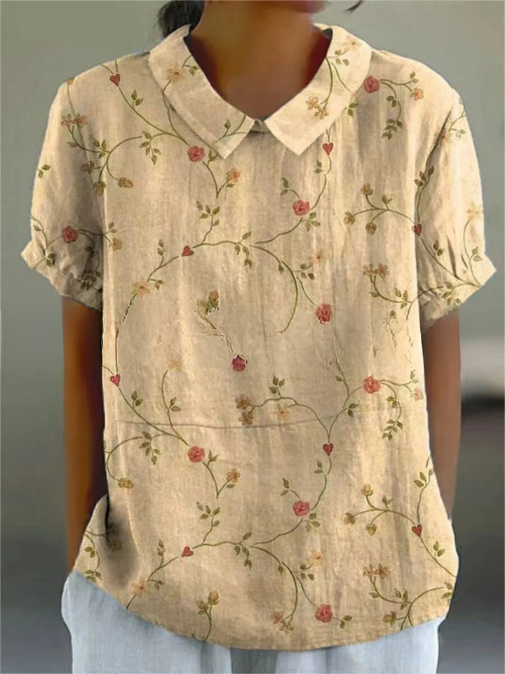 Sommerskjorte til kvinder med et smukt og elegant blomsterdesign, der skaber en frisk og charmerende stil.
