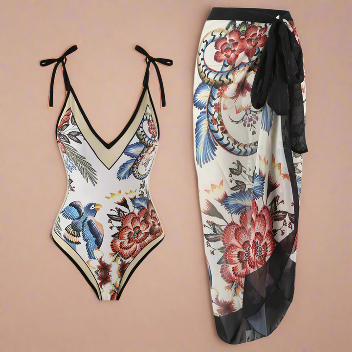 Kvinder mørkeblå strandsæt med pareo og blomsterprint, ideelt som stilfuldt badetøj til strand og poolparty.