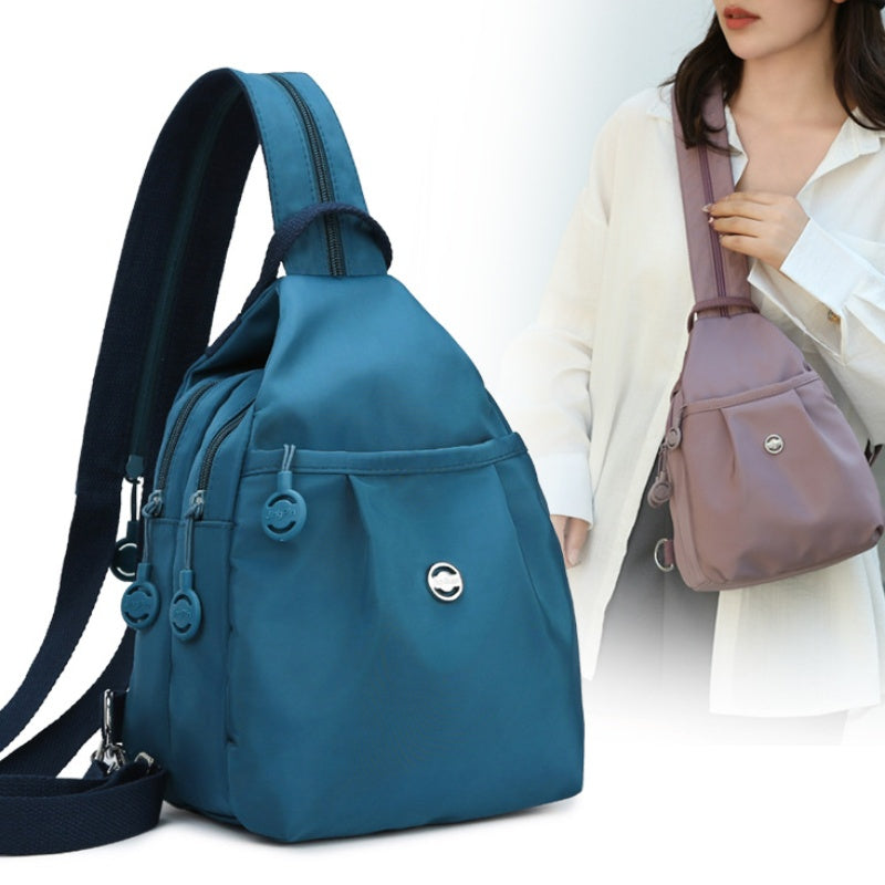 Elegant multifunktionel oxford-stof taske, skifter let fra crossbody til rygsæk.