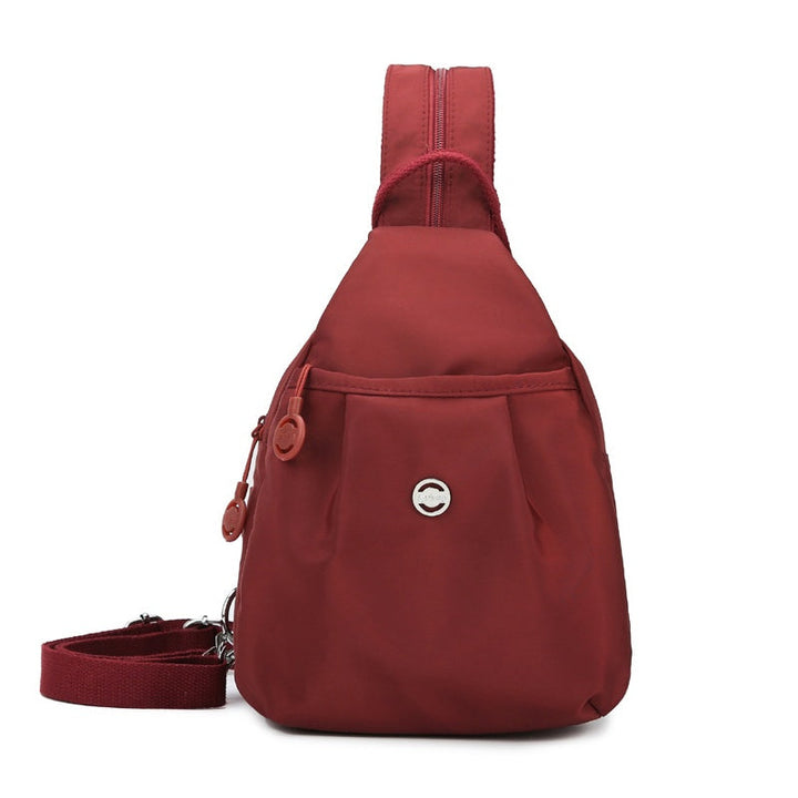Elegant oxford-stof taske, transformerer nemt til rygsæk, crossbody eller skuldertaske.