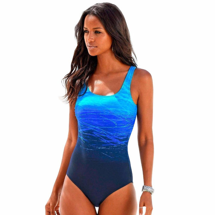 Elegant rundhalset badedragt i én farve med dekorative striber. Perfekt til strand og pool for en stilfuld look.
