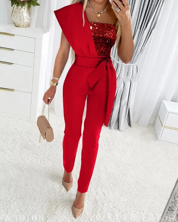 Sort-guld glitrende jumpsuit med elegant one shoulder. Perfekt aften- og festtøj til kvinder.