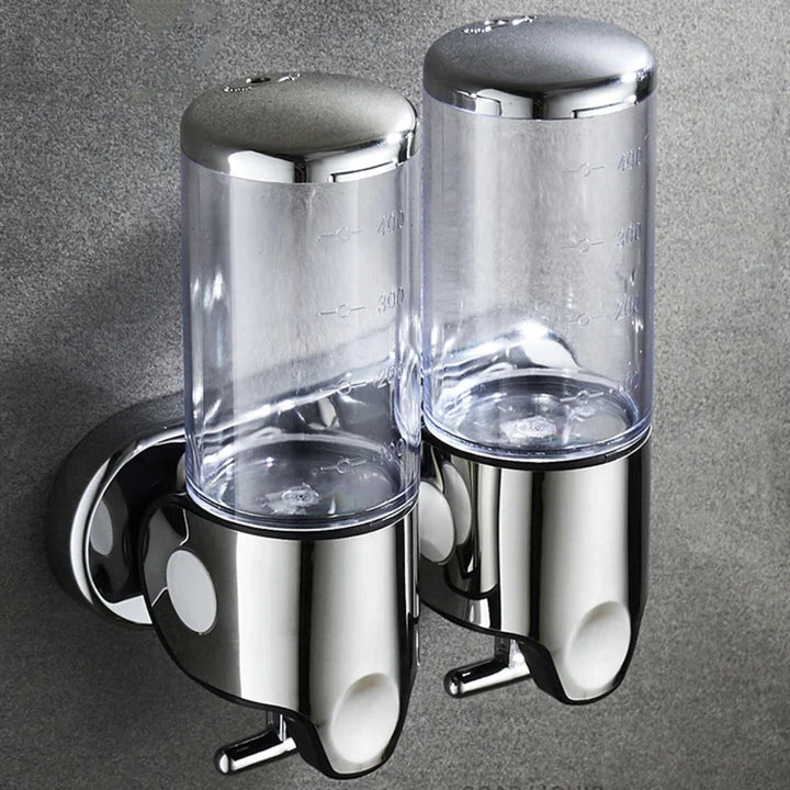 "Elegant vægmonteret sæbedispenser med dobbelt rum, minimalistisk design, gennemsigtige sektioner for nemt overblik."