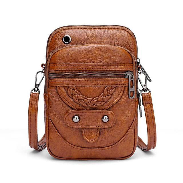 Stilfuld vintage crossbody-taske i brunt PU læder. En elegant og praktisk hverdagstaske til kvinder.