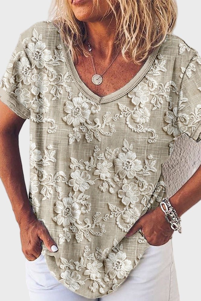 Grå dame blondebluse med korte ærmer og feminin v-udskæring, ideel til sommer og hverdag.