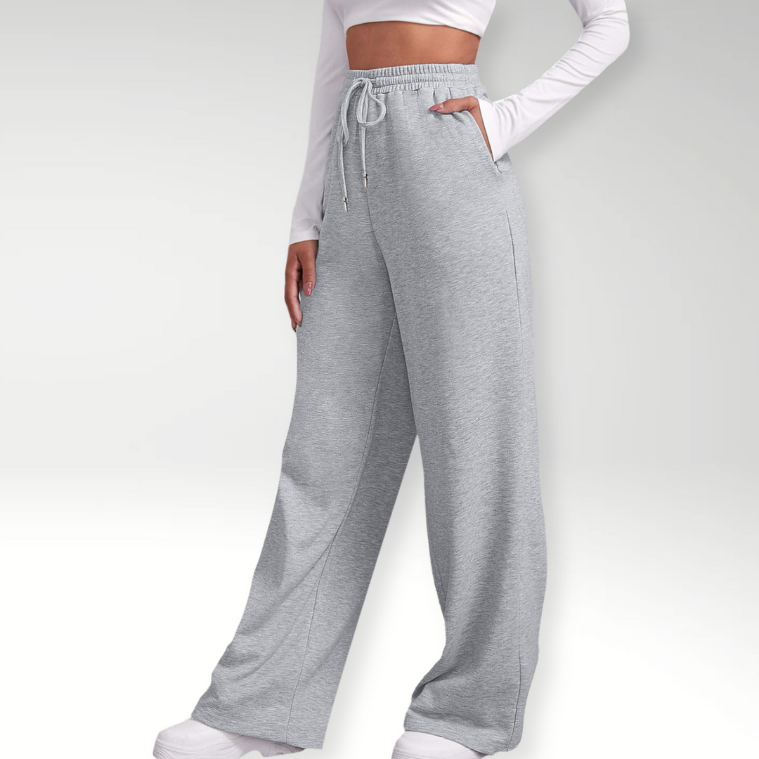 Grå dame sweatpants med høj talje og brede ben. Komfortable og stilfulde athleisure bukser til moderne fritid.
