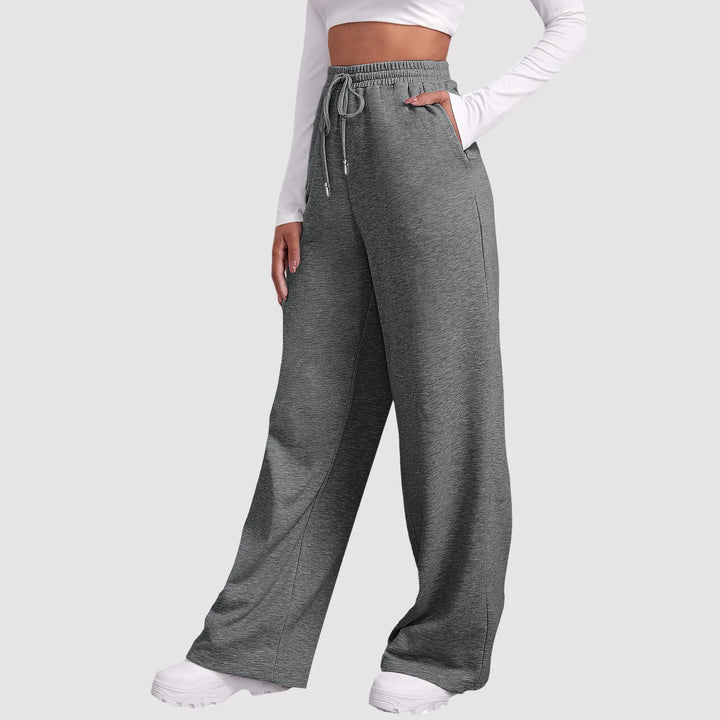 Mørkegrå dame sweatpants med høj talje og brede ben. Moderne og stilfulde for en afslappet athleisure look.