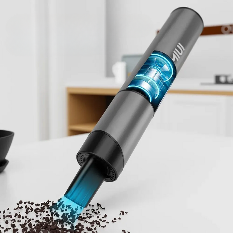 Kompakt grå/grøn USB ministøvsuger. Perfekt til hurtig rengøring af små rum.