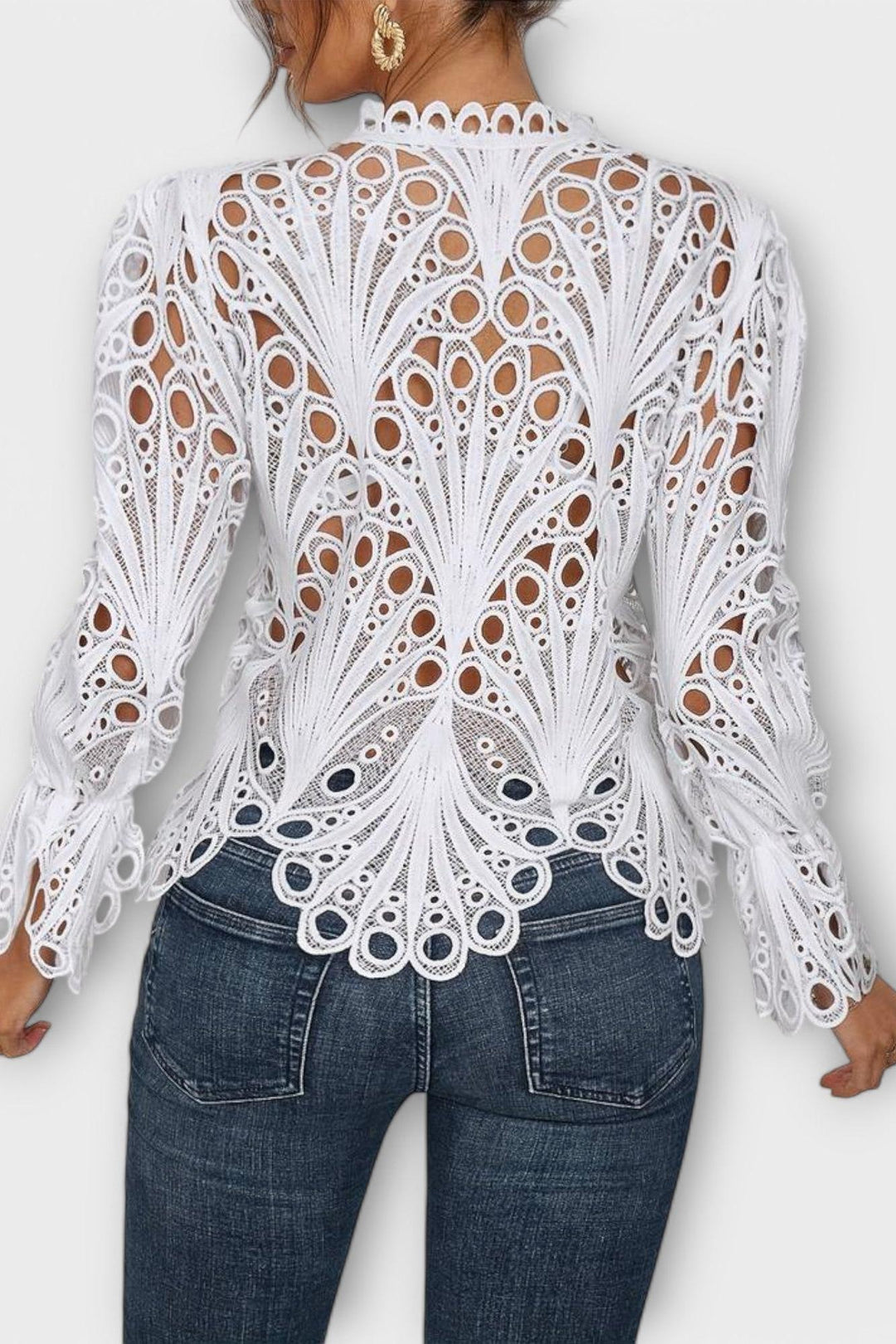 Damebluse i hvid blonde med intrikat mønster og et moderne transparent design.