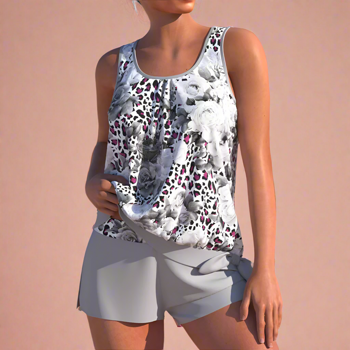 Elegant og afslappet kvinders sommersæt med blomstret mønster. Komfortabelt top- og shorts-outfit til stranden.