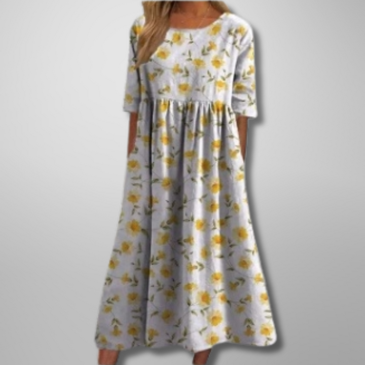 Yndefuld blomstret damekjole, afslappet og elegant midi-længde til sommerens fester og hverdag.