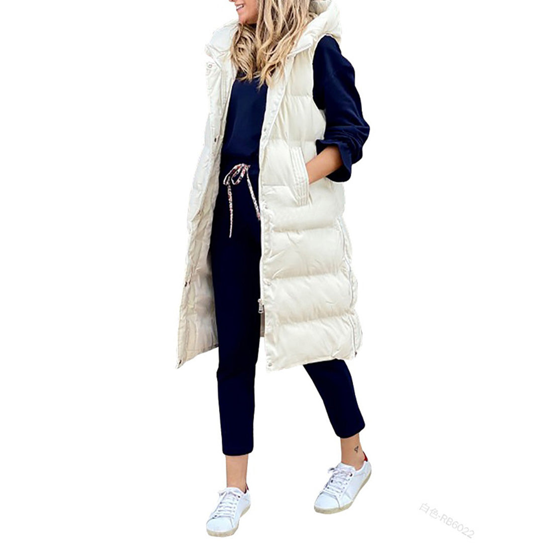 Mørkegrøn lang dame hætte puffer vest. Ideel til udendørs brug og et moderne lagdelt look.