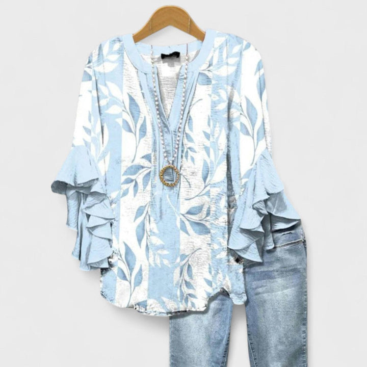Gul blomstret sommerbluse til kvinder. Elegant og luftig letvægtsbluse perfekt til kontoret.