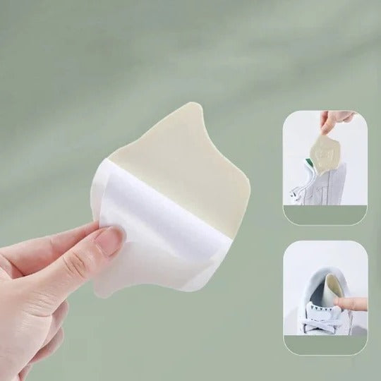 Nærbillede af ergonomiske unisex hælindlæg i sort, designet for optimal fodpleje og stabiliserende pasform.