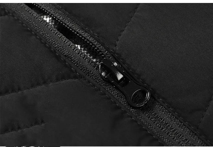 Model bærer sort opvarmet fritidsvest, der holder kroppen varm. Optimal unisex beklædning til vinteren.